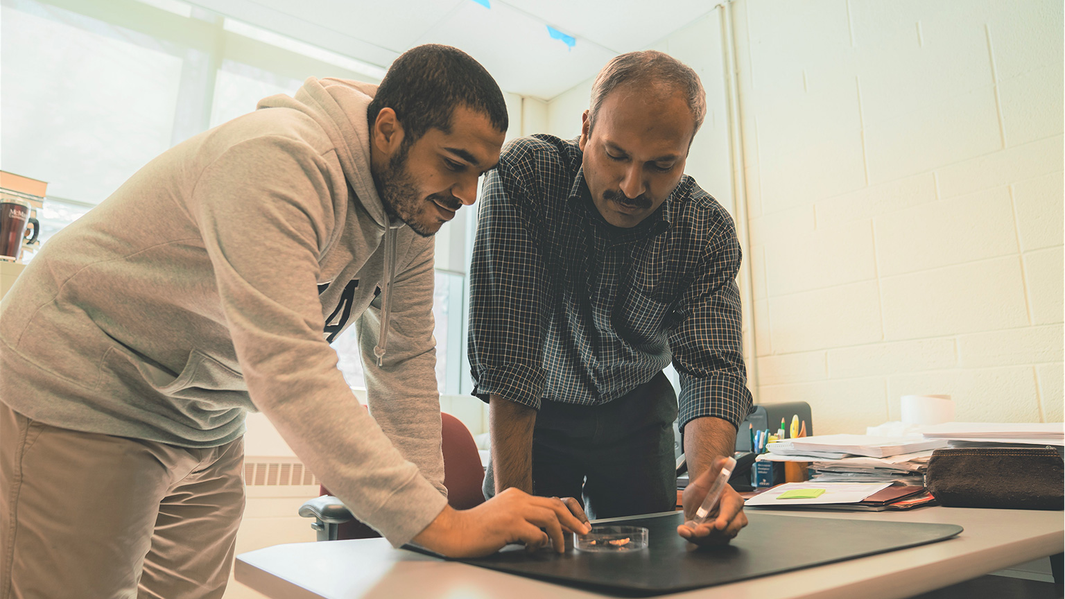 Ravi Selvaganapathy and student look at fireproof sensor