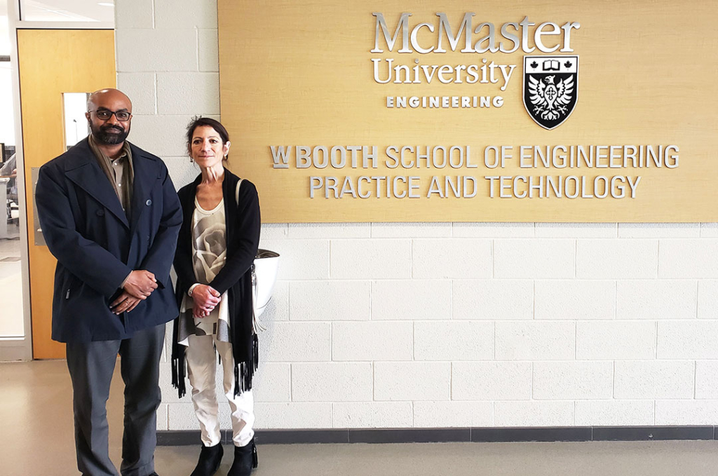 Gussai Sheikheldin and Gail Krantzberg stand beside a wall that says W Booth School of Engineering Practice and Technology