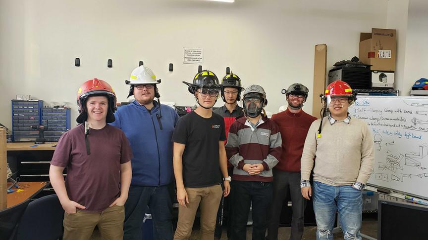 group of people wearing firefighter helmets.