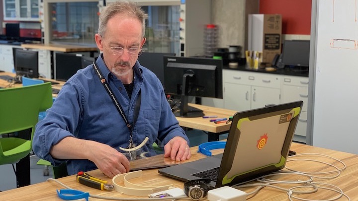 Mike Noseworthy works on putting a face shield together