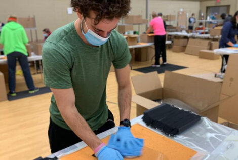 A person wearing PPE packages face masks