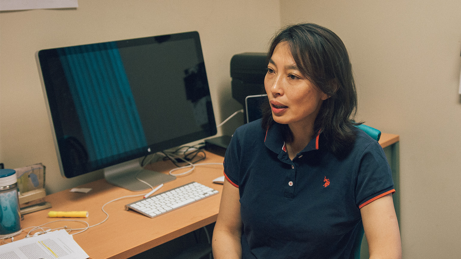 Rong Zheng sits at their desk