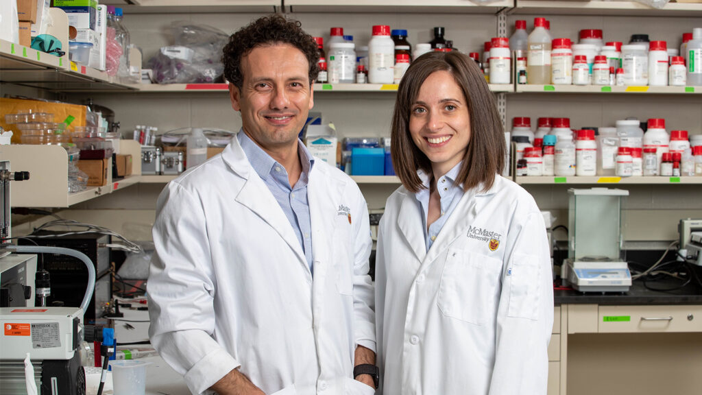 Tohid Didar and Leyla Soleymani stand together in a lab wearing lab coats