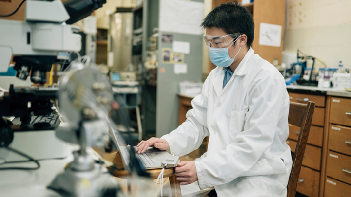 Chunyang Zhang, PhD Candidate, poses in a lab