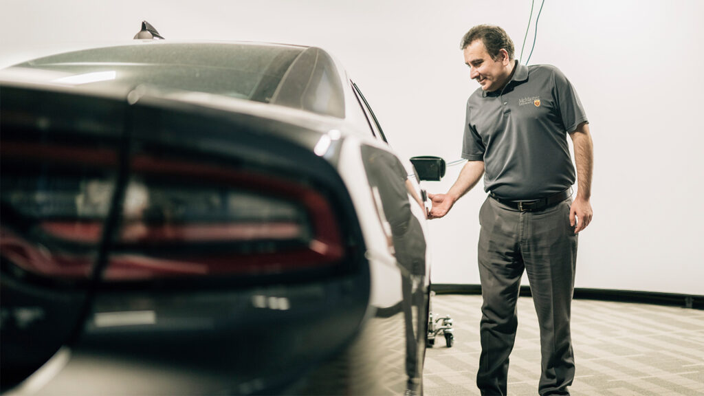 Ali Emadi opening a car door