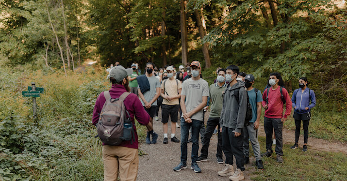 a group of students walking through a nature trail.