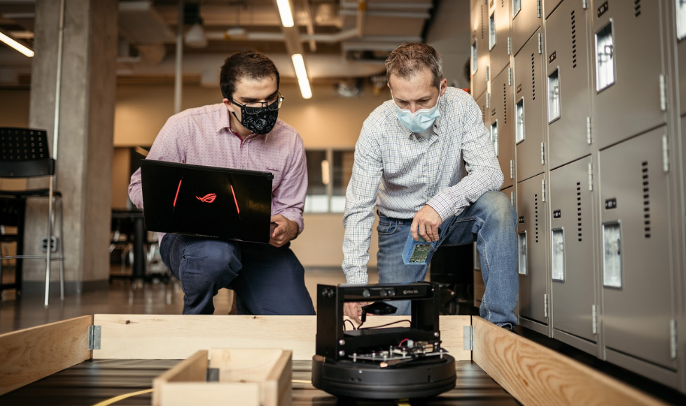 Aj Kourabi and Colin McDonald test a robot.