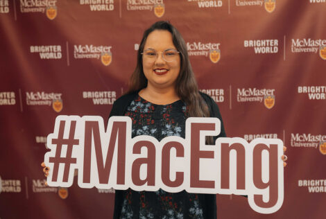 Jaime Jewer holds up a sign that says #MacEng.