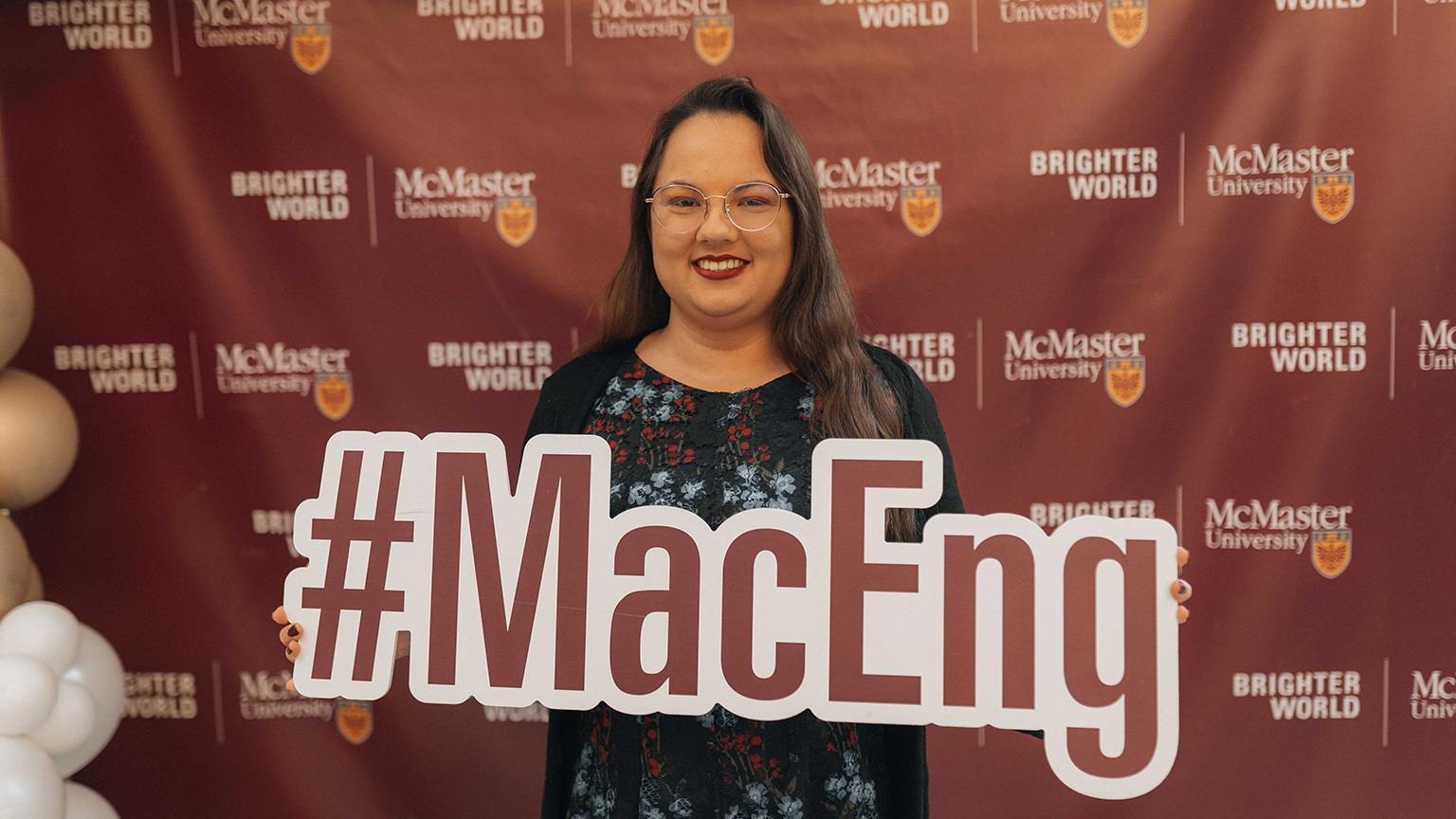 Jaime Jewer holds up a sign that says #MacEng.