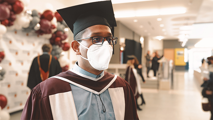 Hosnee Mobarak stands in a cap and gown.