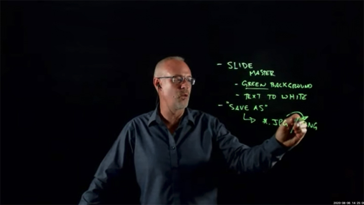 Michael Justason writes on a lightboard