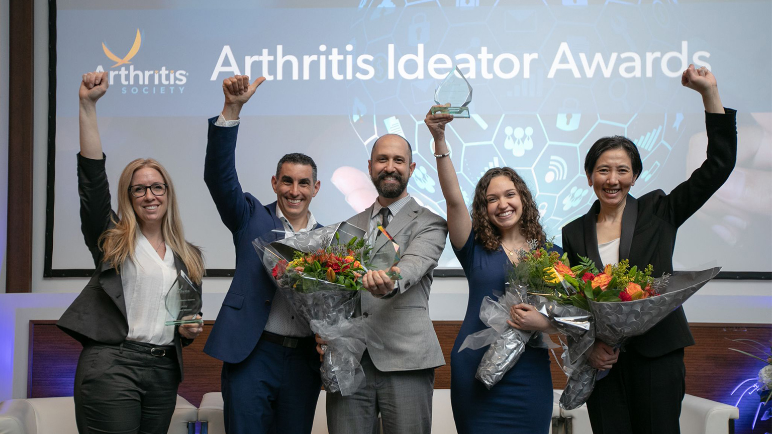 Winners of the Arthritis Ideator Awards hold their arms up