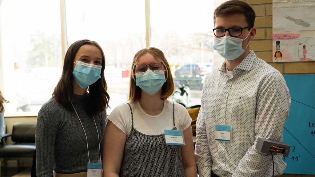 Three group members from the Rotator Rehab project pose for the camera.