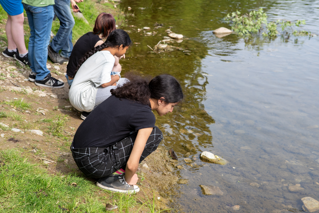 Adriana Johnson watches the tobacco float on the water. “Placing the tobacco in the river acknowledges where we are and lets creation know what we are about to do. It allows us to bring our minds together before the event,” said Chris Martin, Indigenous Program Facilitator at SNP.  