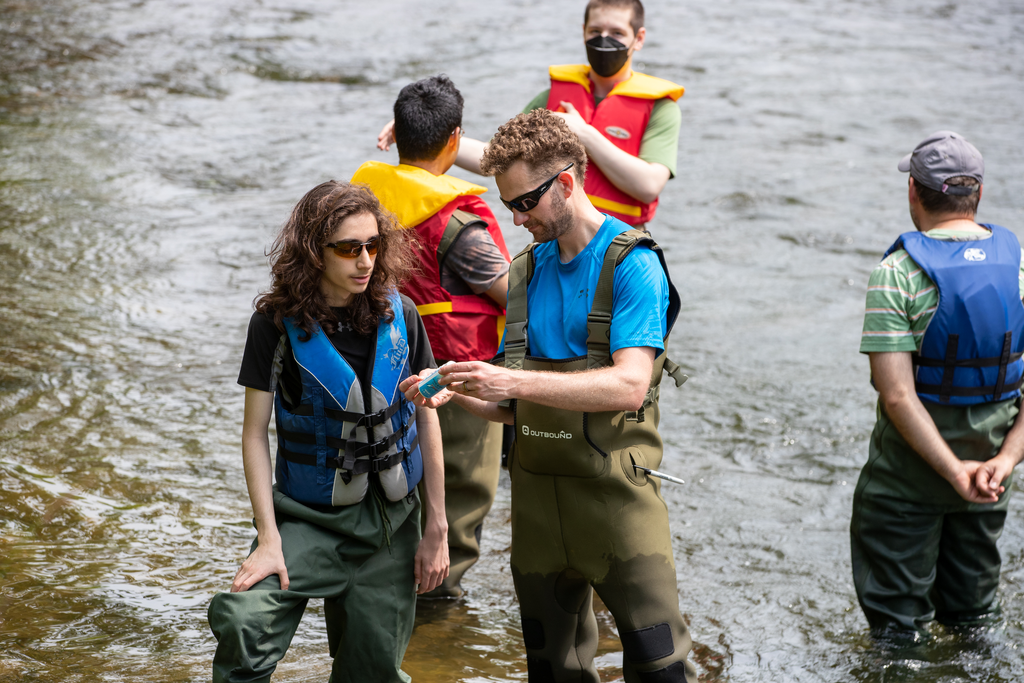 Charles de Lannoy chats with Grade 9 student Hameed Sharef while they use technologies to understand the ecology of the water to evaluate its health.