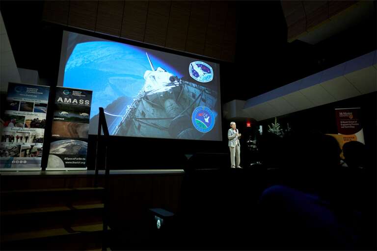 Roberta Bondar presents from the stage of L.R. Wilson Hall.