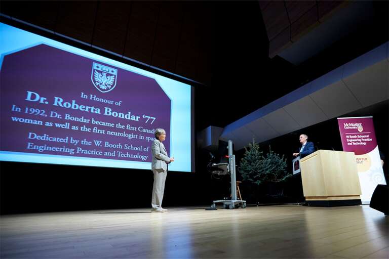 David Farrar presents Roberta Bondar with a plaque honouring her achievement as the first Canadian woman and neurologist in space.