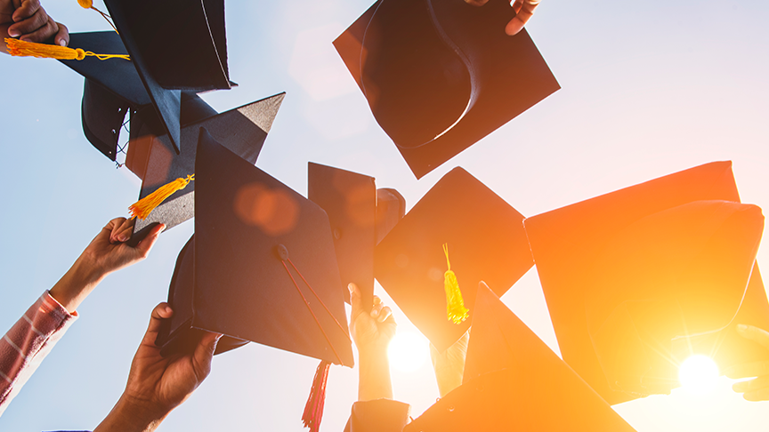 grad caps are thrown in the air