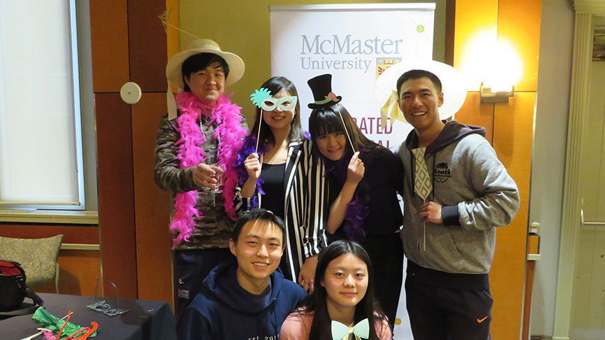 students pose with props in photobooth
