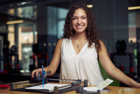 Lianna Genovese poses with her Guided Hands device