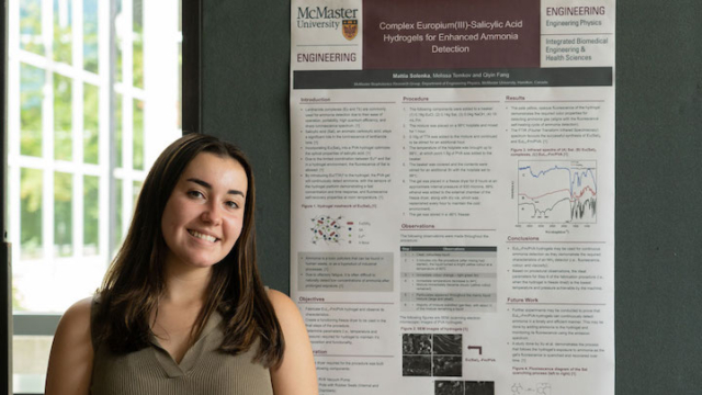 person standing in front of a presentation board.