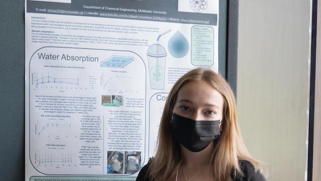 person standing in front of a presentation board.