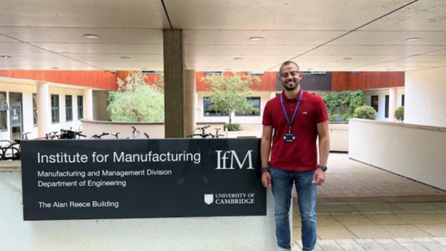 man standing outside of the Institute for Manufacturing at the University of Cambridge.