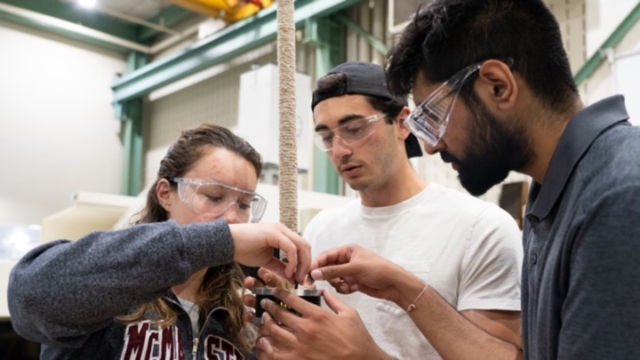 three people constructing a torch.