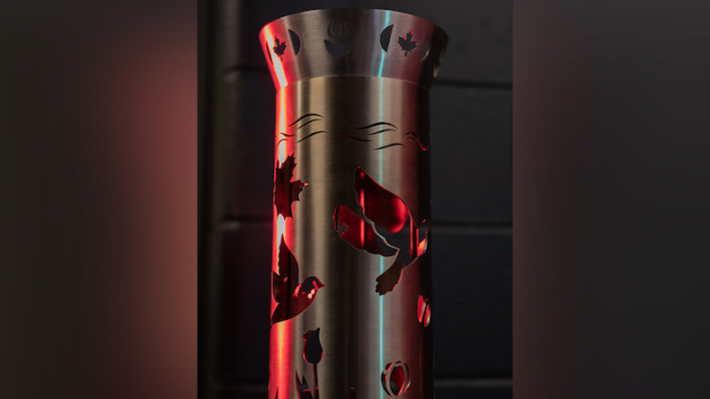 close up of the torch showing bird and leaf cut outs on the steel