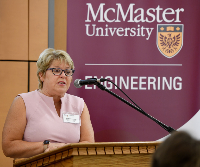 Heather Sheardown speaking into a mic at a podium