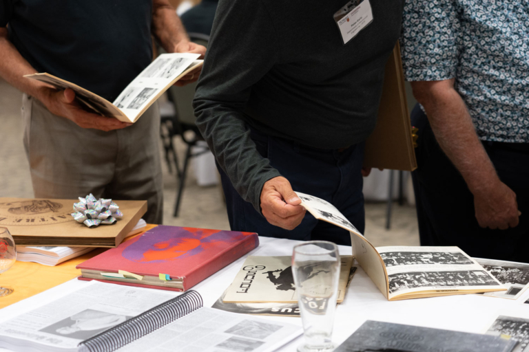 a person flipping through a Marmor on a table of books