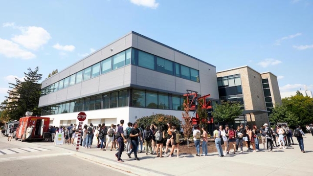 students on campus in front of a building.