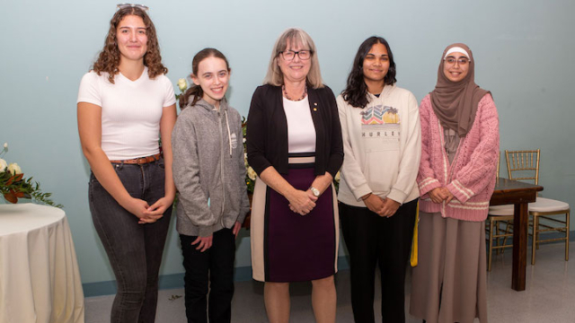 alt="Donna Strickland with a group of female engineering students."