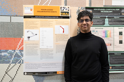 a person standing in front of their presentation board. 