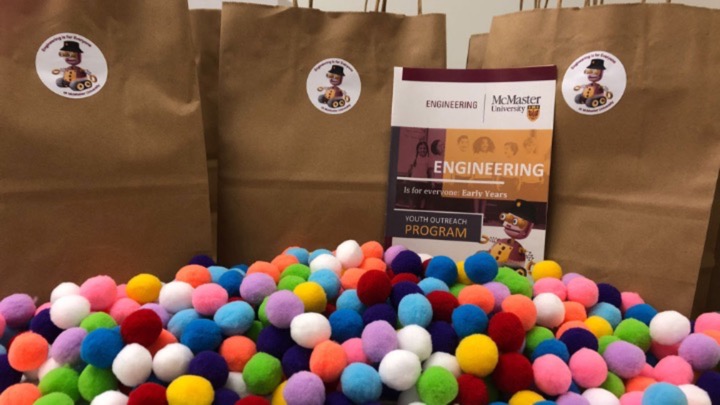 a pile of pompoms in front of brown bags.