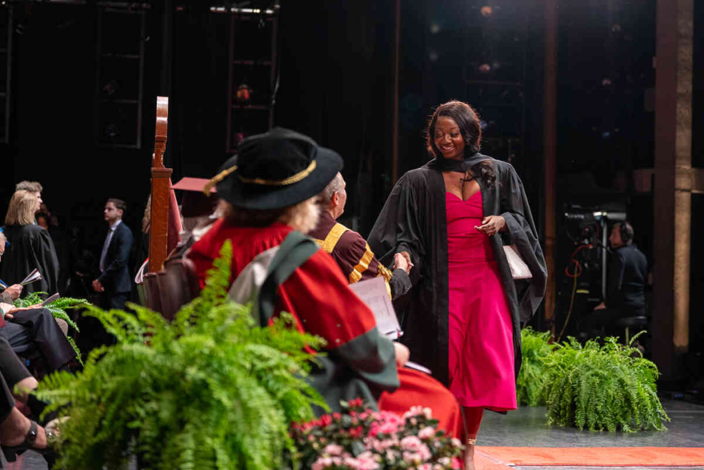 Student walking onto stage at convocation