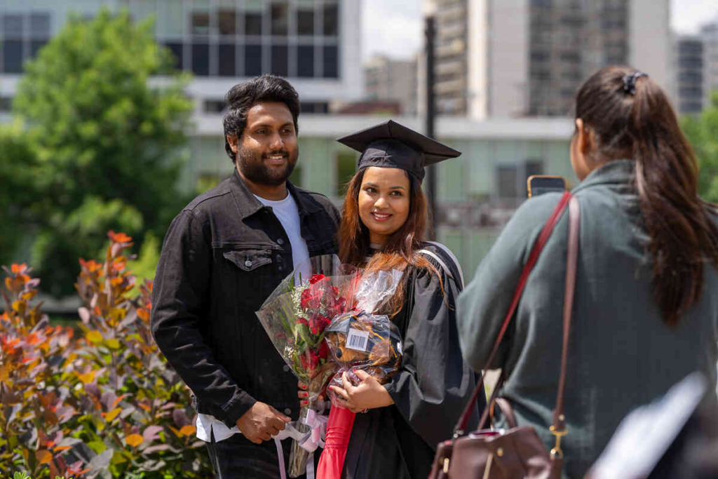 Students taking picture outside of convocation hall