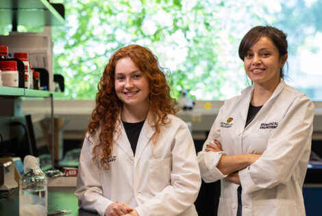 Grad Maryam Badv and student Shannon Gomes-Hunt pose in a University of Calgary lab