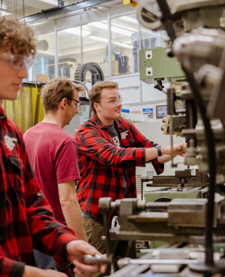 Students working on machines in the shop