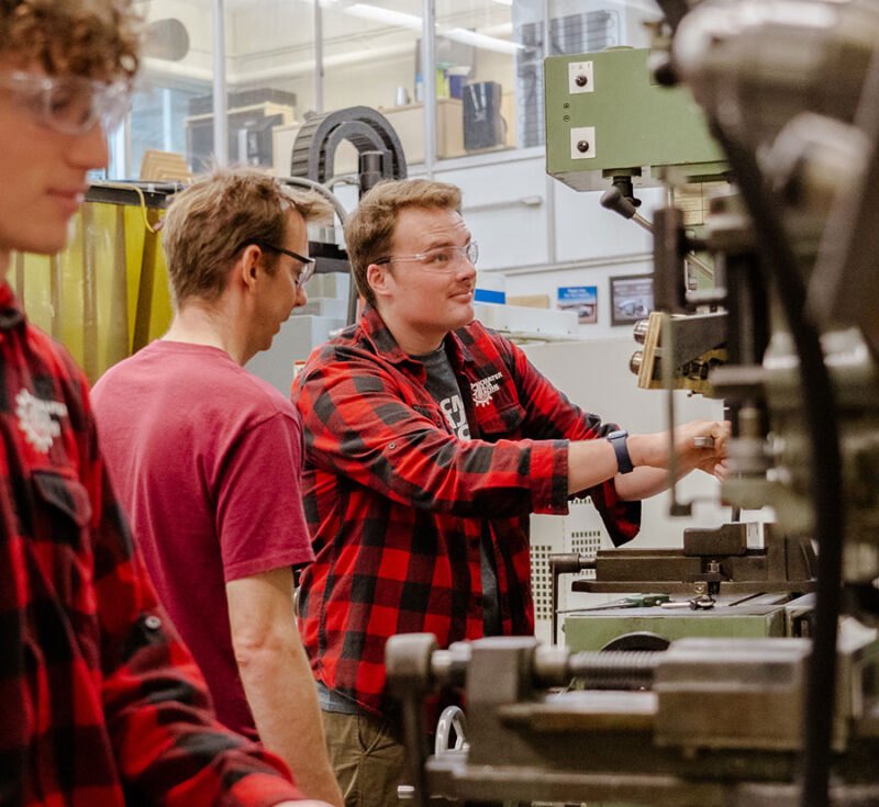 Students working on machines in the shop