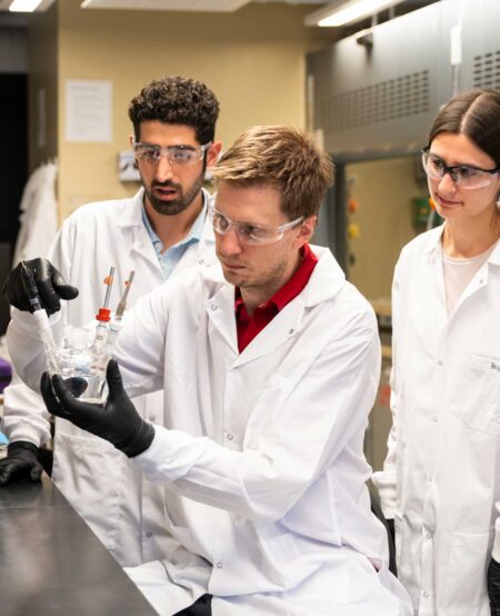 Prof Drew Higgins and students in lab