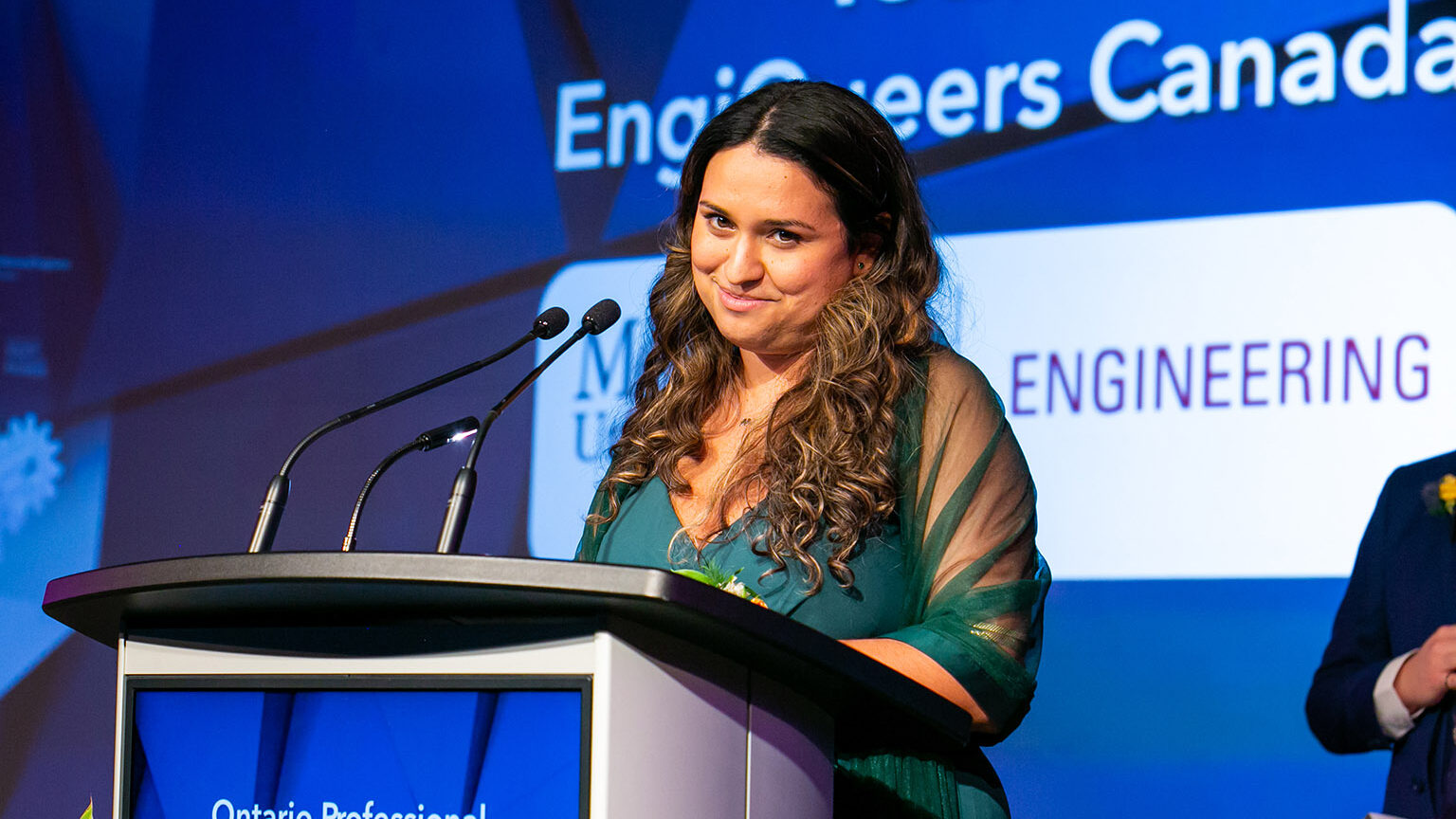 Vanessa Raponi accepting an award on stage