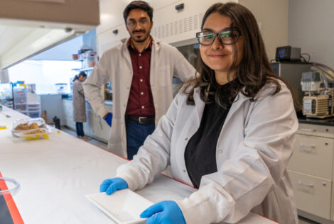 grad students in a lab with their container prototype