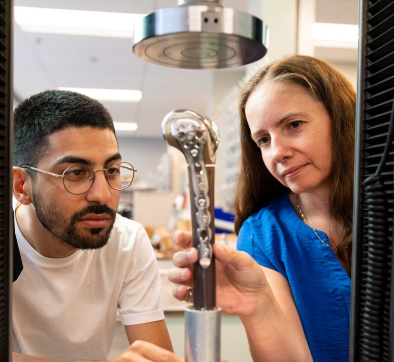 Student and Cheryl examining bone structure in lab