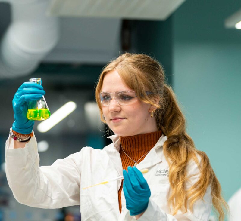 Female student examining sample in Chem Eng Lab
