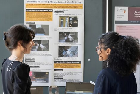 two people looking at a presentation board.