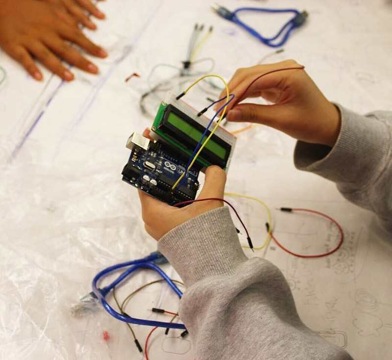 Hands working with a circuit