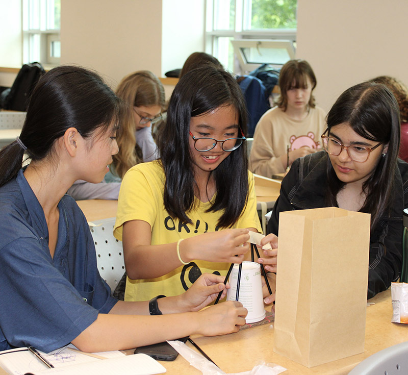 High school students doing a STEM building activity in collaboration