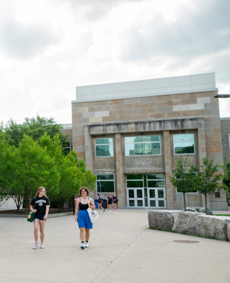 Two students walking outside the Information Technology Building