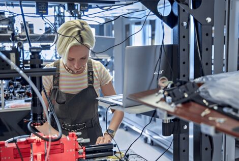 Xanadu Hardware Team Member works at an optical table in the Xanadu lab.